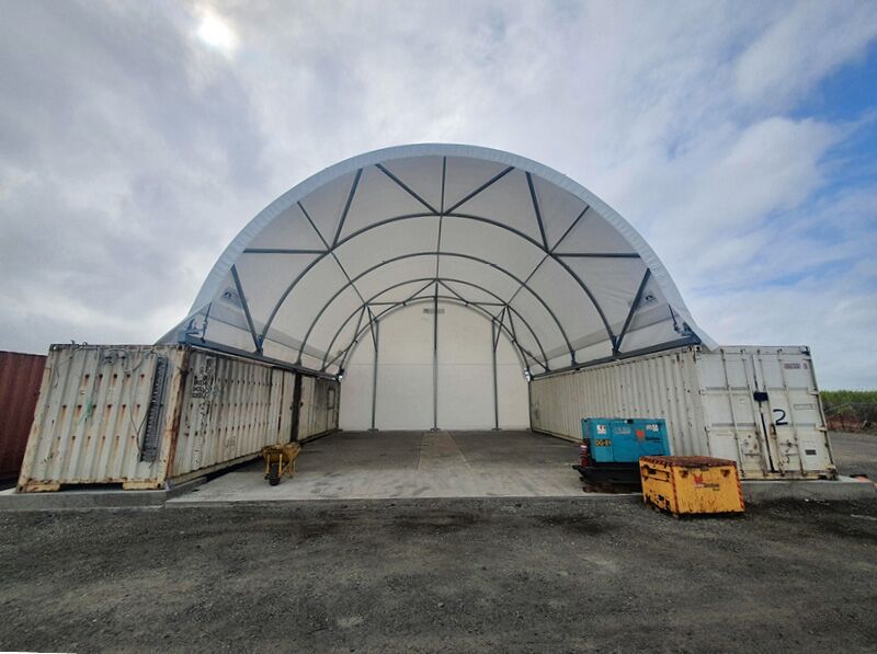 Container-Mounted Shelter with Endwall A container-mounted shelter featuring a full endwall structure for enclosed storage or workspace.