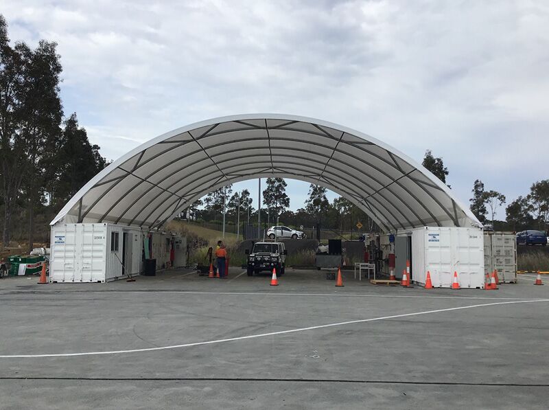 Container-Mounted Shelter GAL-10 A container-mounted fabric shelter used as a functional workspace with open sides and sturdy design.